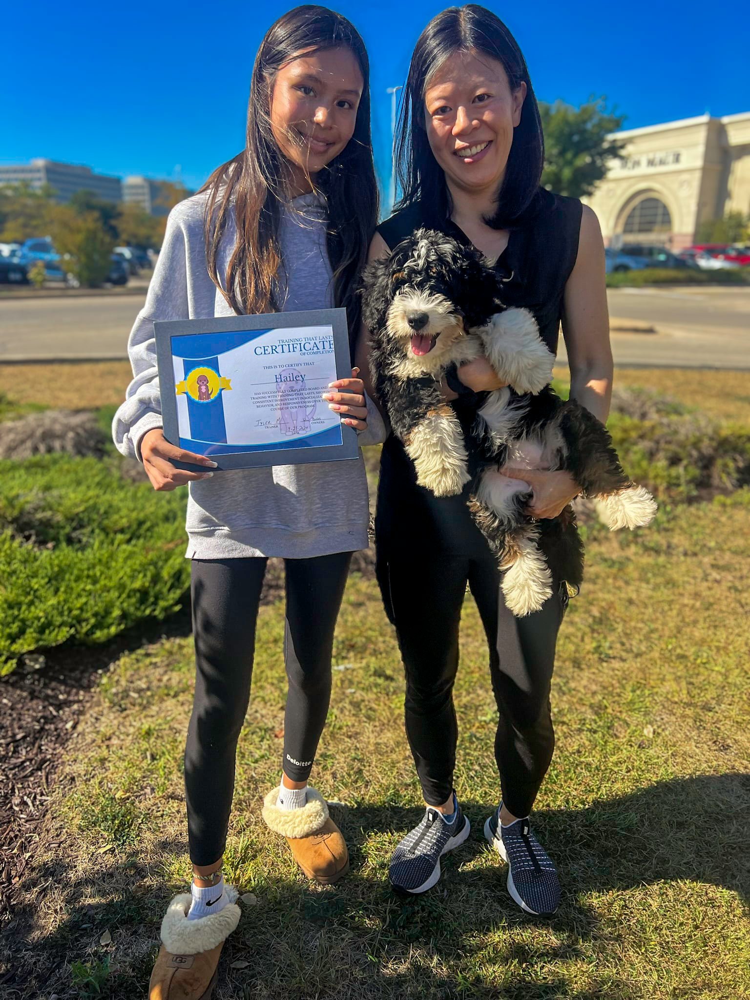 A Family Picking Up Their Trained Bernedoodle Puppy From Training That Lasts Which They Bought From Hoosier Canines.