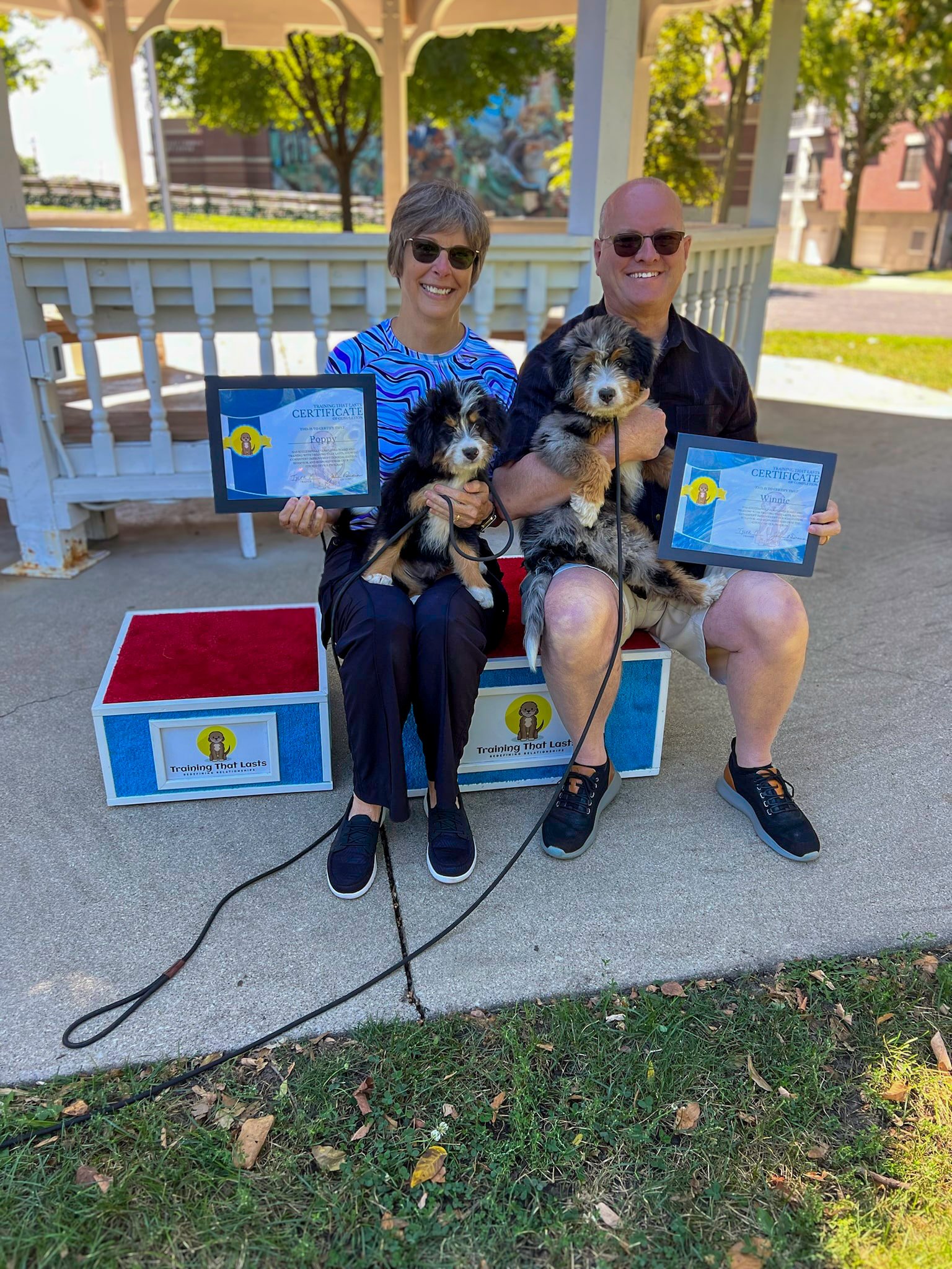 A Family Picking Up Their Trained Bernedoodle Puppy From Training That Lasts Which They Bought From Hoosier Canines.
